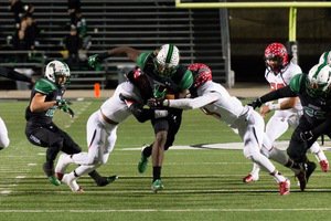 Southlake Carrol RB Lil Jordan Humphrey breaks through the Cedar Hill defense in the first round of the 2015 UIL football playoffs  Humphrey accounted for 289 yards and three TDs as the Dragons defeated Cedar Hill 37-33 at Dragon Stadium  Photo by S JohnsonSnappedDragonscom