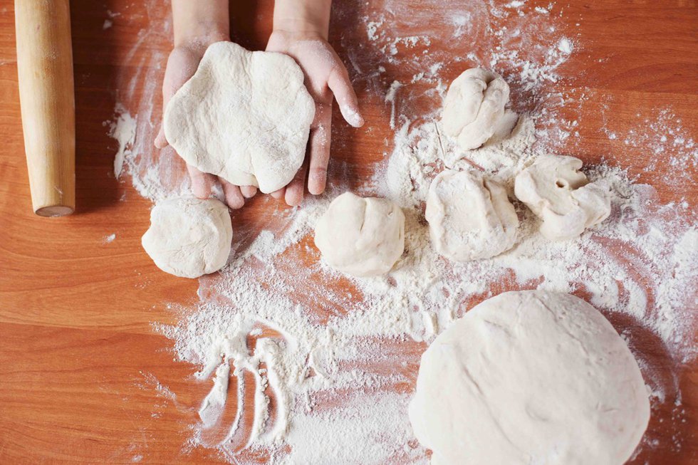 Child holding kneading dough