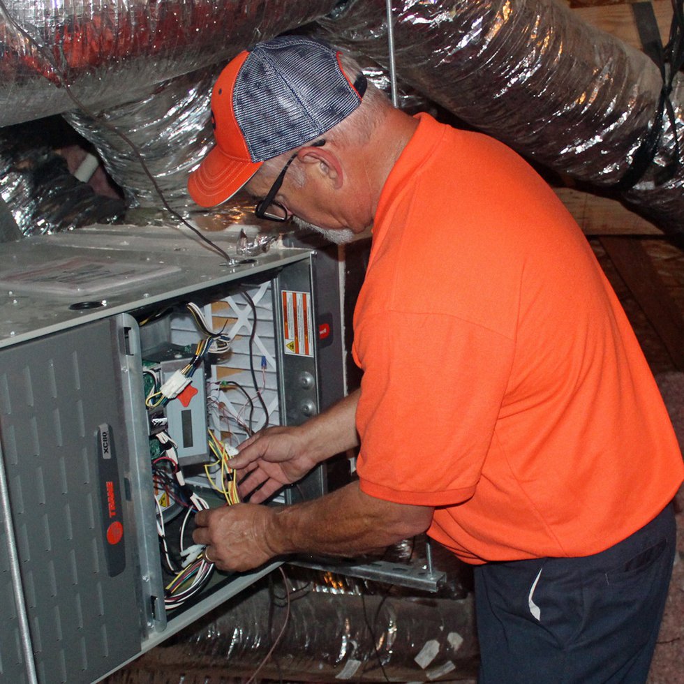 billygo-hvac-tech-checks-for-loose-wiring-during-heater-tune-up.jpg