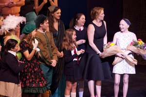 Ella is greeted by Erica Peterman and her friends and cast-mates on stage